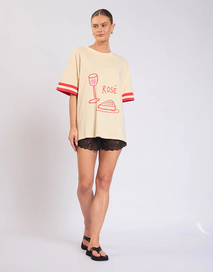 Easy, playful, and made for weekends — the Rosè All Day Tee is your go-to for relaxed styling with a touch of fun.

With its soft cream base, this tee is elevated by ribbed sleeve details that add structure, while the statement front and back prints bring personality from every angle. Designed in a relaxed fit, it’s the perfect throw-on-and-go piece that still feels effortlessly put together.
