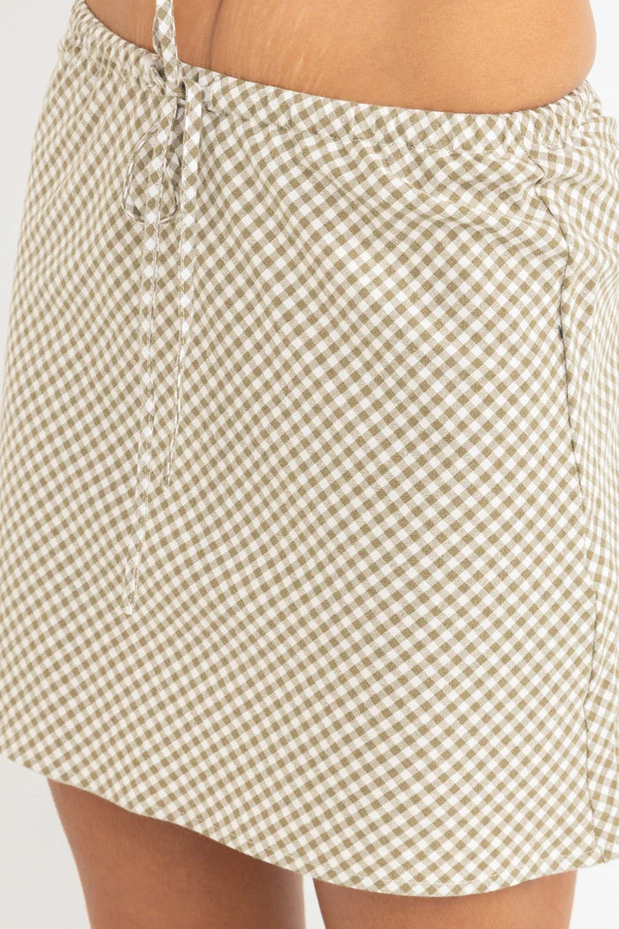 The Lola Check Bias Cut Mini Skirt in Olive adds a touch of charm to your wardrobe. This relaxed-fit mini skirt features an elastic waist with a self-drawcord for easy styling. The bias-cut design offers movement and flow, making it an effortless piece for any occasion.