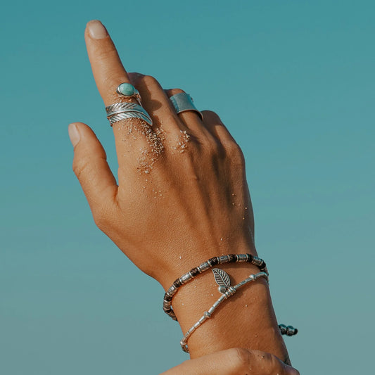 Discover the Bamboo Sea Bracelet, meticulously handcrafted with Hill Tribe Silver and adorned with a polywax cotton band. Symbolising growth and harmony with nature, this bracelet's organic texture and vibrant colours serve as a daily reminder of your connection to the natural world. Experience boho-inspired elegance with Embella's Bamboo Bracelet.