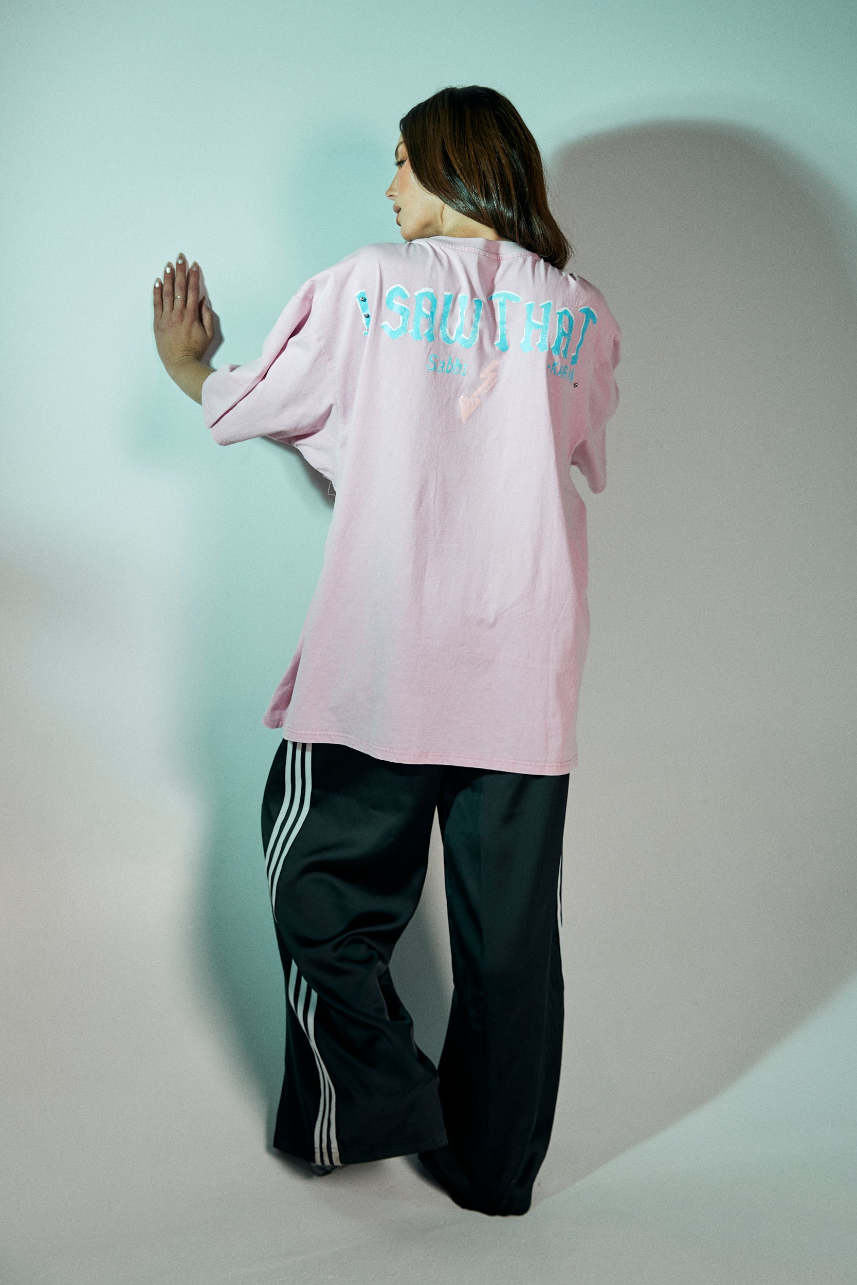 Step into your power with the Karma Queen Bling Tee in Pink – a bold mix of playful charm and streetwear edge. Crafted from 100% cotton with a relaxed, oversized fit, this tee features a statement graphic of the Karma Queen crowned character, brought to life with sparkling rhinestone embellishments for that extra dose of bling.