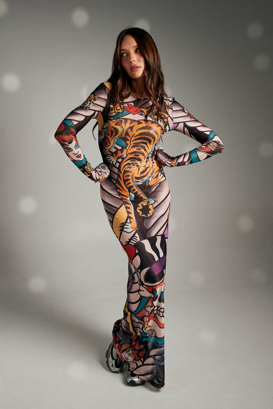 Turn heads and make a statement in The Got Ink Mesh Dress, a body-hugging masterpiece that fuses art and attitude. Crafted from sheer stretch mesh, this long-sleeve maxi dress is drenched in bold tattoo-inspired graphics—tigers, skulls, pin-up icons, and classic ink motifs—that wrap around the body like a second skin. Designed with a sleek silhouette, it flatters every curve while serving unapologetic confidence.