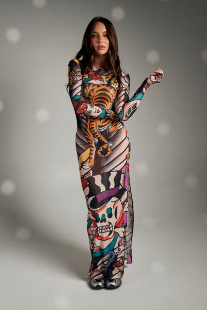 Turn heads and make a statement in The Got Ink Mesh Dress, a body-hugging masterpiece that fuses art and attitude. Crafted from sheer stretch mesh, this long-sleeve maxi dress is drenched in bold tattoo-inspired graphics—tigers, skulls, pin-up icons, and classic ink motifs—that wrap around the body like a second skin. Designed with a sleek silhouette, it flatters every curve while serving unapologetic confidence.