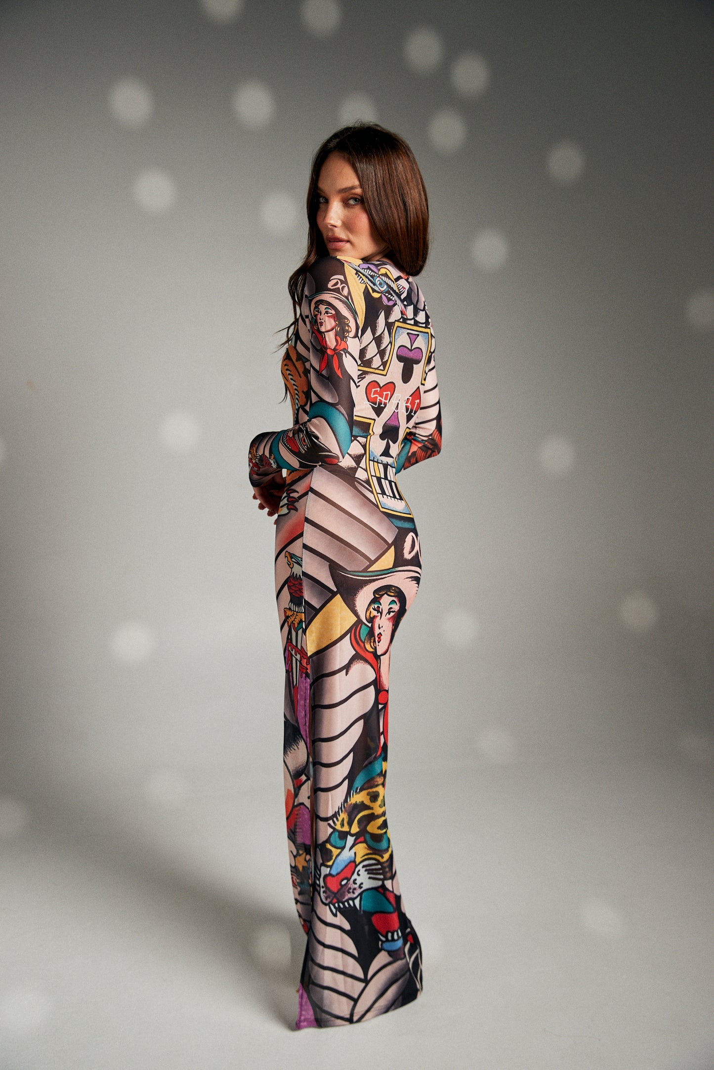 Turn heads and make a statement in The Got Ink Mesh Dress, a body-hugging masterpiece that fuses art and attitude. Crafted from sheer stretch mesh, this long-sleeve maxi dress is drenched in bold tattoo-inspired graphics—tigers, skulls, pin-up icons, and classic ink motifs—that wrap around the body like a second skin. Designed with a sleek silhouette, it flatters every curve while serving unapologetic confidence.