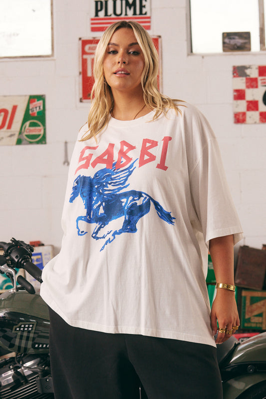 The Very Oversized Rhinestone Tee – Marshmallow
Crank up the attitude with the Very Oversized Rhinestone Tee in Marshmallow. Featuring a fierce blue winged stallion print and bold “SABBI” branding across the front, this tee brings major rock ‘n’ roll energy. The back hits just as hard, with the quote “It’s hard to be a diamond in a rhinestone world” – a reminder to stay unapologetically you. Crafted from soft cotton in an ultra-roomy fit, it's made for lounging, layering, or leading the pack.