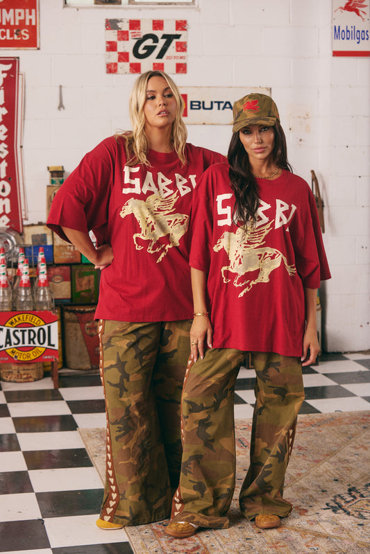 The Very Oversized Rhinestone Tee – RED
Crank up the attitude with the Very Oversized Rhinestone Tee in Red. Featuring a fierce blue winged stallion print and bold “SABBI” branding across the front, this tee brings major rock ‘n’ roll energy. Crafted from soft cotton in an ultra-roomy fit, it's made for lounging, layering, or leading the pack.