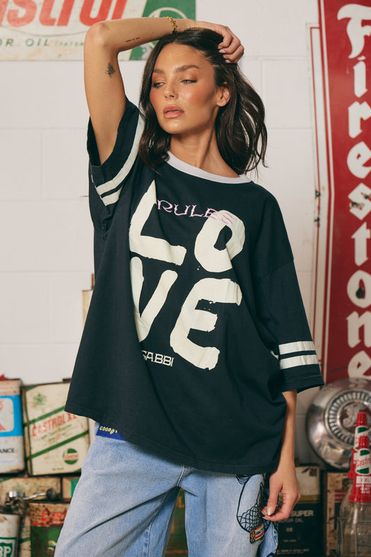 The Love Revolution Tee – Black
Big love, zero rules. The Love Revolution Tee in Black is your go-to for fearless self-expression. Featuring varsity sleeve stripes, a relaxed oversized fit, and bold distressed-style "LOVE" typography with a pop of pink in “Rules,” this tee is a statement in more ways than one. Crafted from soft, breathable cotton and finished with SABBÍ’s signature edge, it’s made for rebels with heart.

Style it with denim, sneakers, or leather — and lead your own revolution.