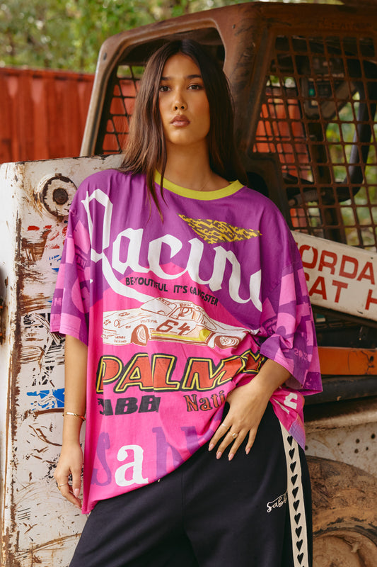 Go bold or go home with The Very Oversized It’s Gangster Tee—a statement piece that’s as unapologetic as you are. Bursting with high-energy graphics, this tee features a race-day inspired front print complete with a vintage-style car, bold lettering, and pops of neon. The back brings just as much heat with an eclectic collage of prints and empowering slogans, making it a wearable piece of art.

Cut in a seriously oversized fit for that slouchy, street-ready silhouette, this tee is made from soft, breathable