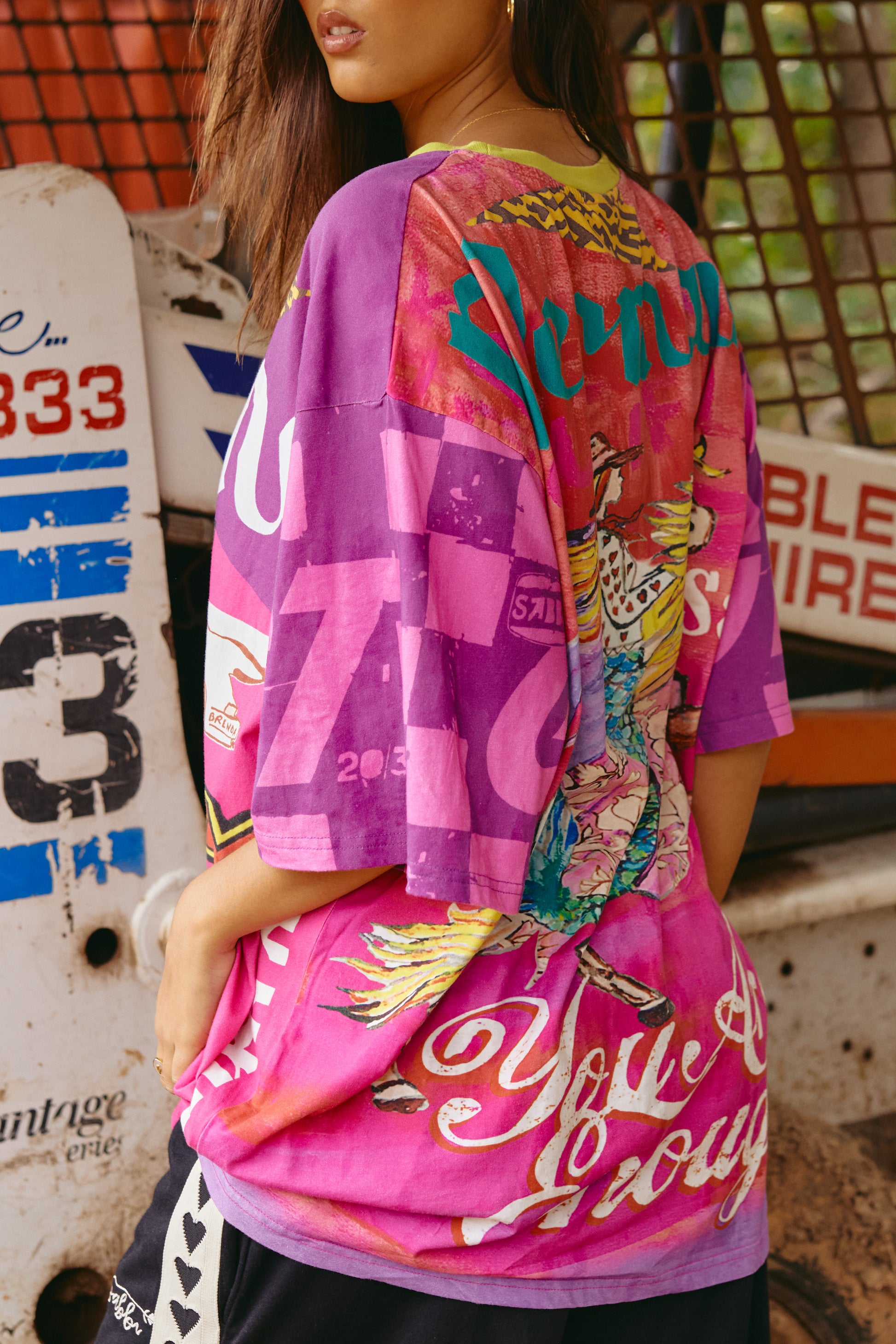 Go bold or go home with The Very Oversized It’s Gangster Tee—a statement piece that’s as unapologetic as you are. Bursting with high-energy graphics, this tee features a race-day inspired front print complete with a vintage-style car, bold lettering, and pops of neon. The back brings just as much heat with an eclectic collage of prints and empowering slogans, making it a wearable piece of art.

Cut in a seriously oversized fit for that slouchy, street-ready silhouette, this tee is made from soft, breathable