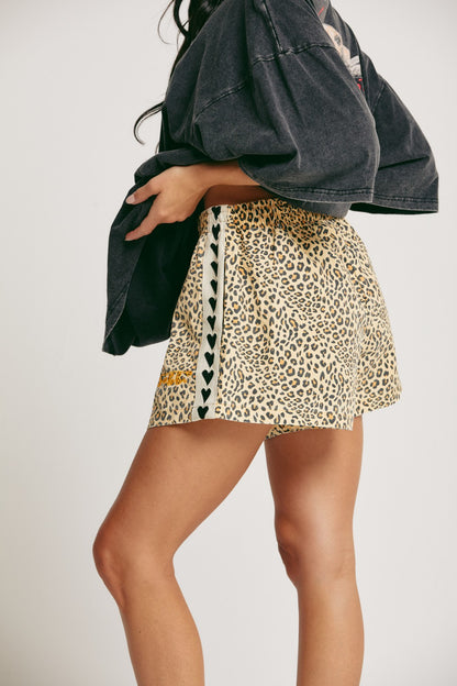 Unleash your wild side with The Mini Hearts Drill Shorts - Leopard, a bold mix of fierce and playful. Designed for all-day comfort with a street-chic edge, these shorts feature a striking leopard print that roars with attitude — balanced by signature contrast heart detailing down the sides for a touch of love-infused flair.