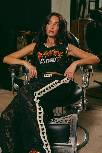 Make a statement in The Raving Hearts Lace Pants - Black, where grunge meets goddess. Crafted from soft, floral lace with a sheer finish, these pants embody the perfect clash of romance and rock ‘n’ roll. The relaxed, wide-leg silhouette flows effortlessly while the contrast heart trim running down each leg adds a bold, playful twist.