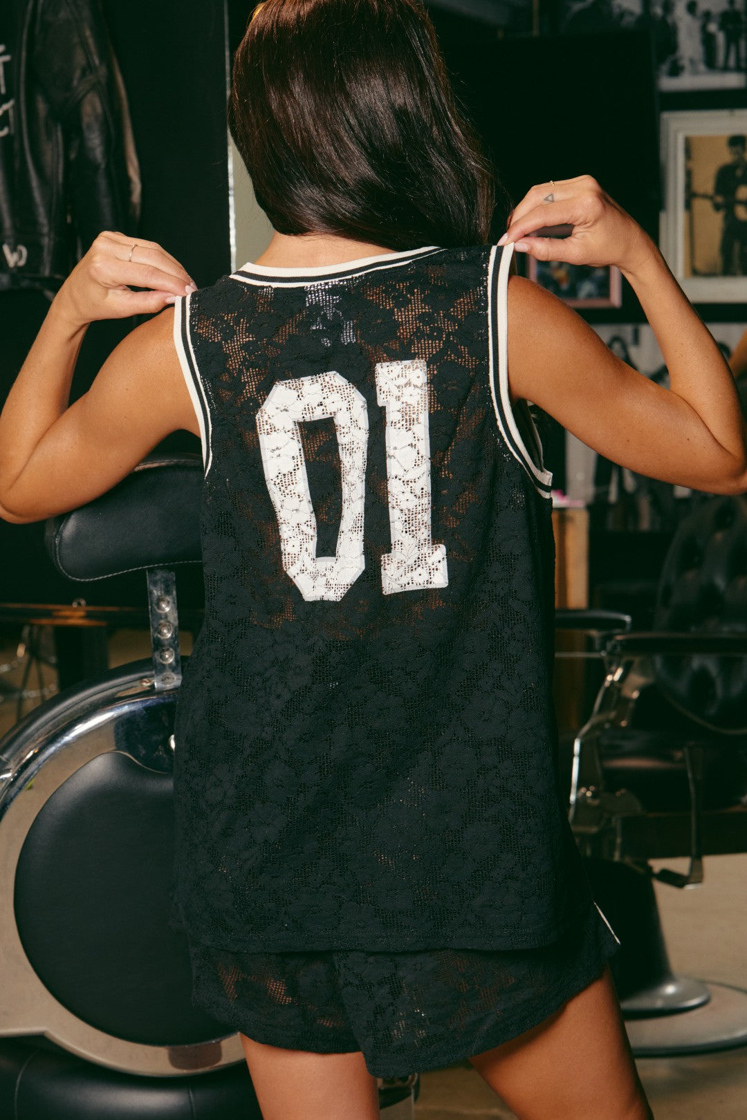 Bring bold energy to your wardrobe with The Lace Basketball Singlet - Black, where sport meets seduction. Crafted from intricate floral lace, this oversized singlet reimagines classic athletic style with a rebellious, feminine edge.