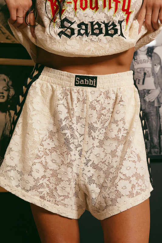 Playfully feminine with a rebellious edge, The Mini Hearts Lace Shorts - Cream are your new wardrobe MVP. Crafted from soft, floral lace in a dreamy cream hue, these shorts fuse sport-inspired energy with romantic details for a look that’s equal parts sweet and bold.