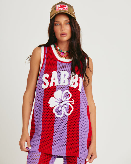 THE KNIT B-BALL SINGLET — PURPLE STRIPE -SABBI

Bring the heat and serve all the courtside attitude in THE KNIT B-BALL SINGLET – PURPLE STRIPE. A bold, retro-sport moment meets handcrafted energy, this statement knit is here to steal the spotlight (and hearts).

Designed in eye-popping purple and fire red stripes, this breathable open-weave crochet singlet is your new go-to for festival days, coastal hangs, or any moment you feel like being unmissable. Featuring an oversized fit, contrast rib trims, and our