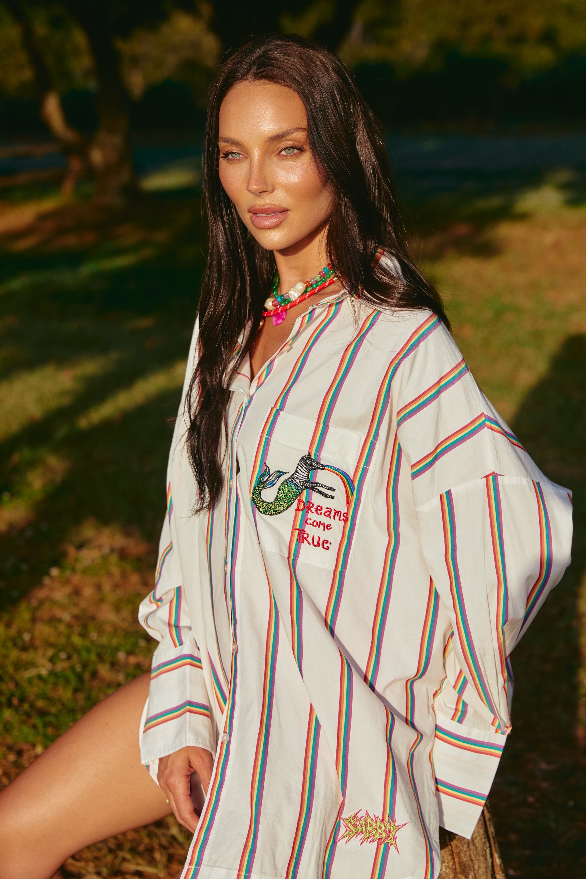 Meet your new happy place in shirt form — the Don Julio Shirt - Rainbow Dreams. This oversized statement piece radiates pure joy with its vibrant rainbow stripes and playful vintage energy.