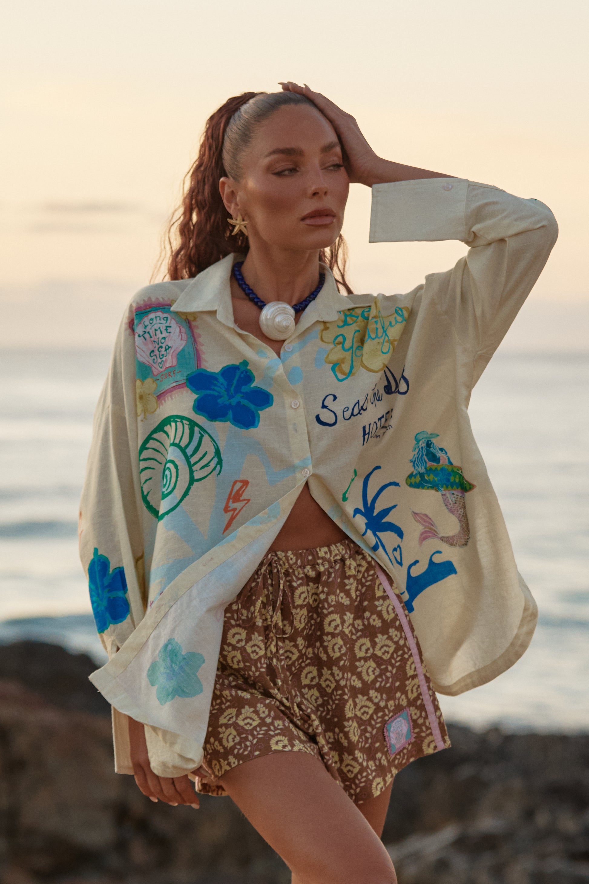 Sabbi - Meet the shirt that does it all. The Don Julio Shirt in Cream – Seas The Day is your throw-on-and-go statement piece, blending effortless coastal cool with bold, hand-drawn Sabbi artwork. Lightweight, breezy and intentionally oversized, it’s made for salty skin, sun-faded afternoons and dancing straight from beach to bar.