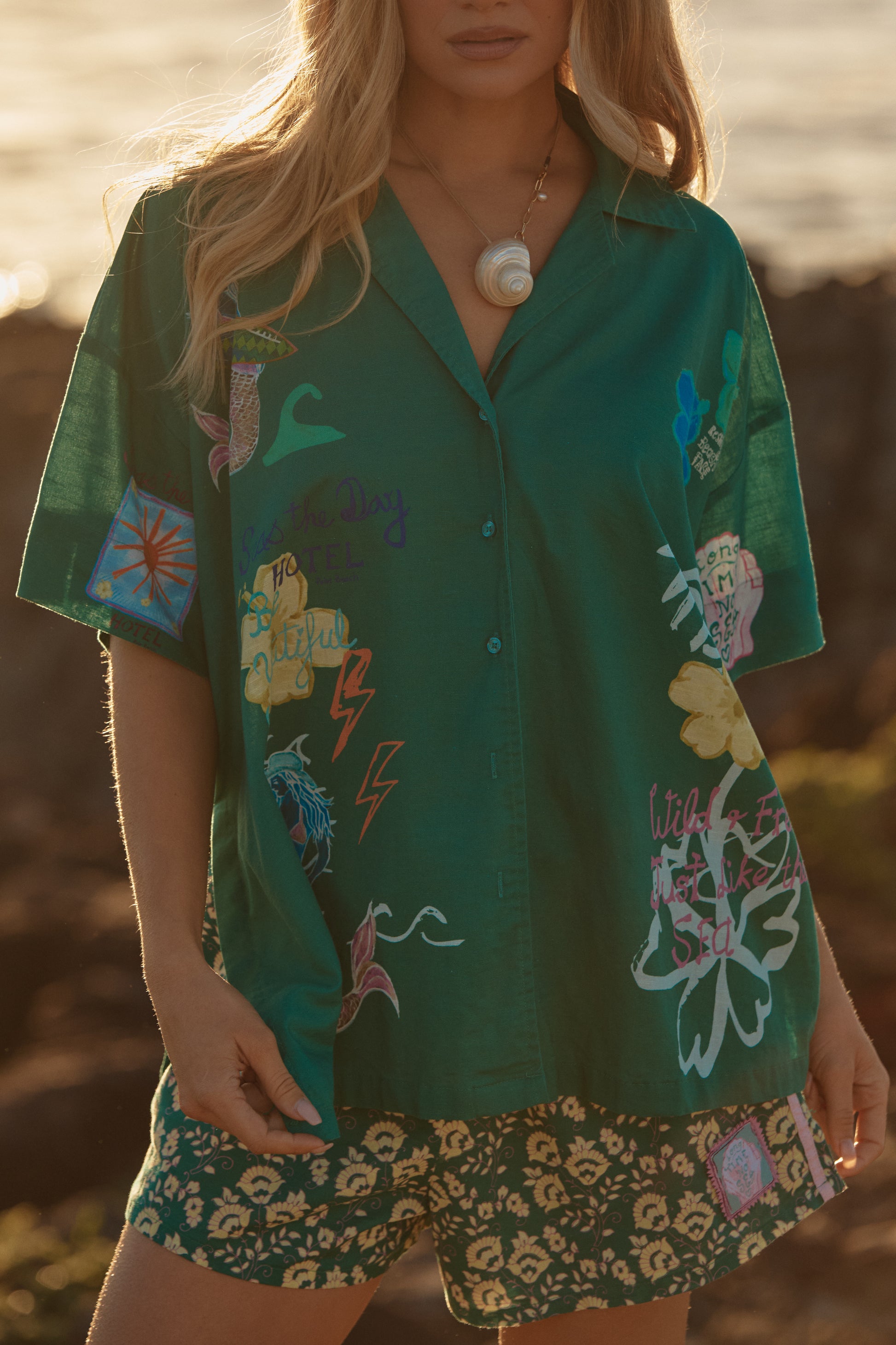 Sabbi - Meet your new statement layer. The Patron Shirt – Green Seas The Day is made for golden hours, salty air and spontaneous adventures. Crafted in a lightweight, breezy fabric, this relaxed button-up features the signature Seas The Day artwork scattered across a rich green base for a bold, coastal feel.