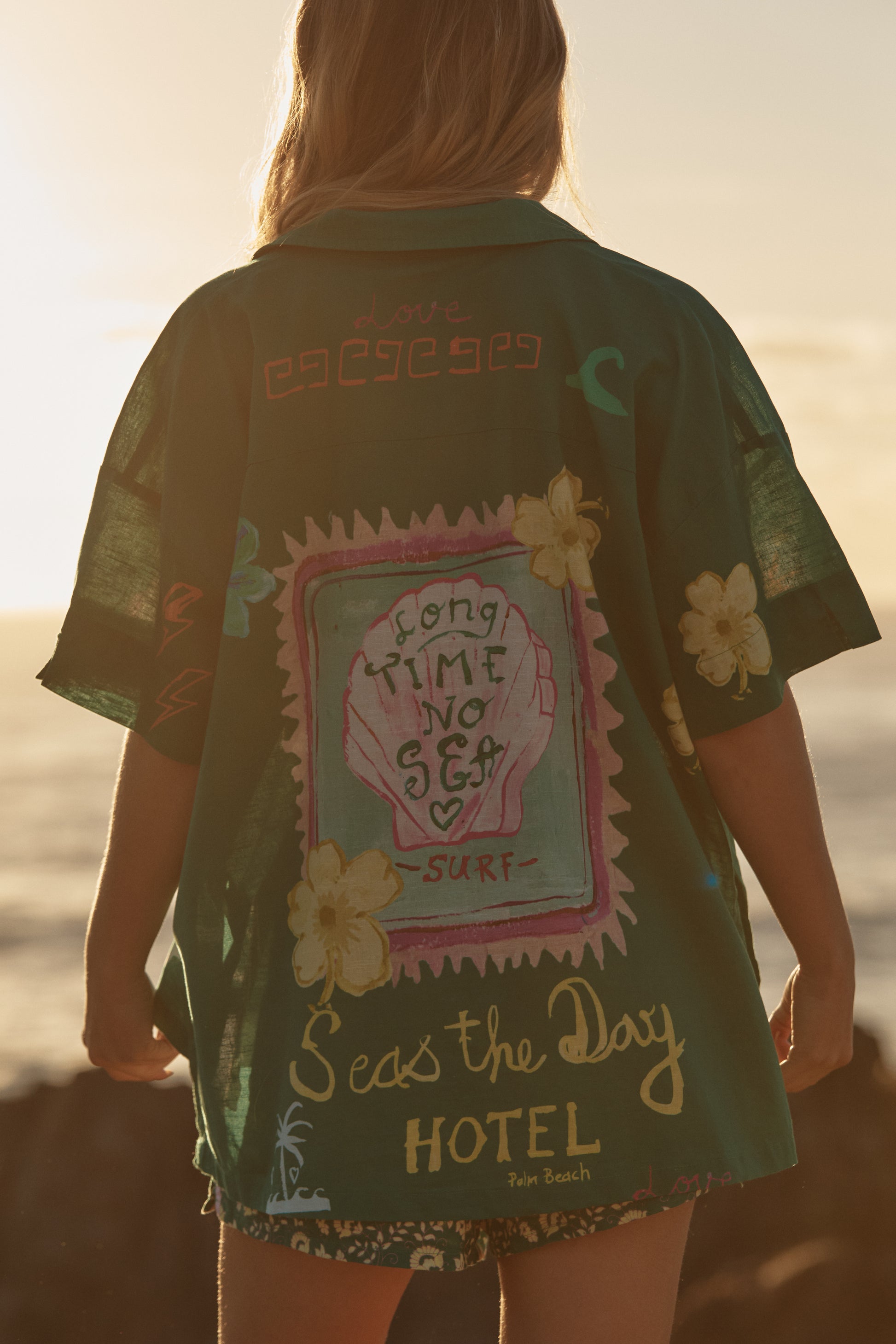 Sabbi - Meet your new statement layer. The Patron Shirt – Green Seas The Day is made for golden hours, salty air and spontaneous adventures. Crafted in a lightweight, breezy fabric, this relaxed button-up features the signature Seas The Day artwork scattered across a rich green base for a bold, coastal feel.