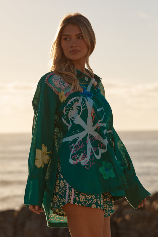 Sabbi - Meet your statement layer for sun-soaked days and golden-hour nights. The Don Julio Shirt – Green is effortlessly cool with a relaxed, oversized fit and a sheer, lightweight feel that moves beautifully with you. Drenched in rich green tones and detailed with playful Seas the Day artwork, this piece brings vintage surf energy with a bold Sabbi twist.