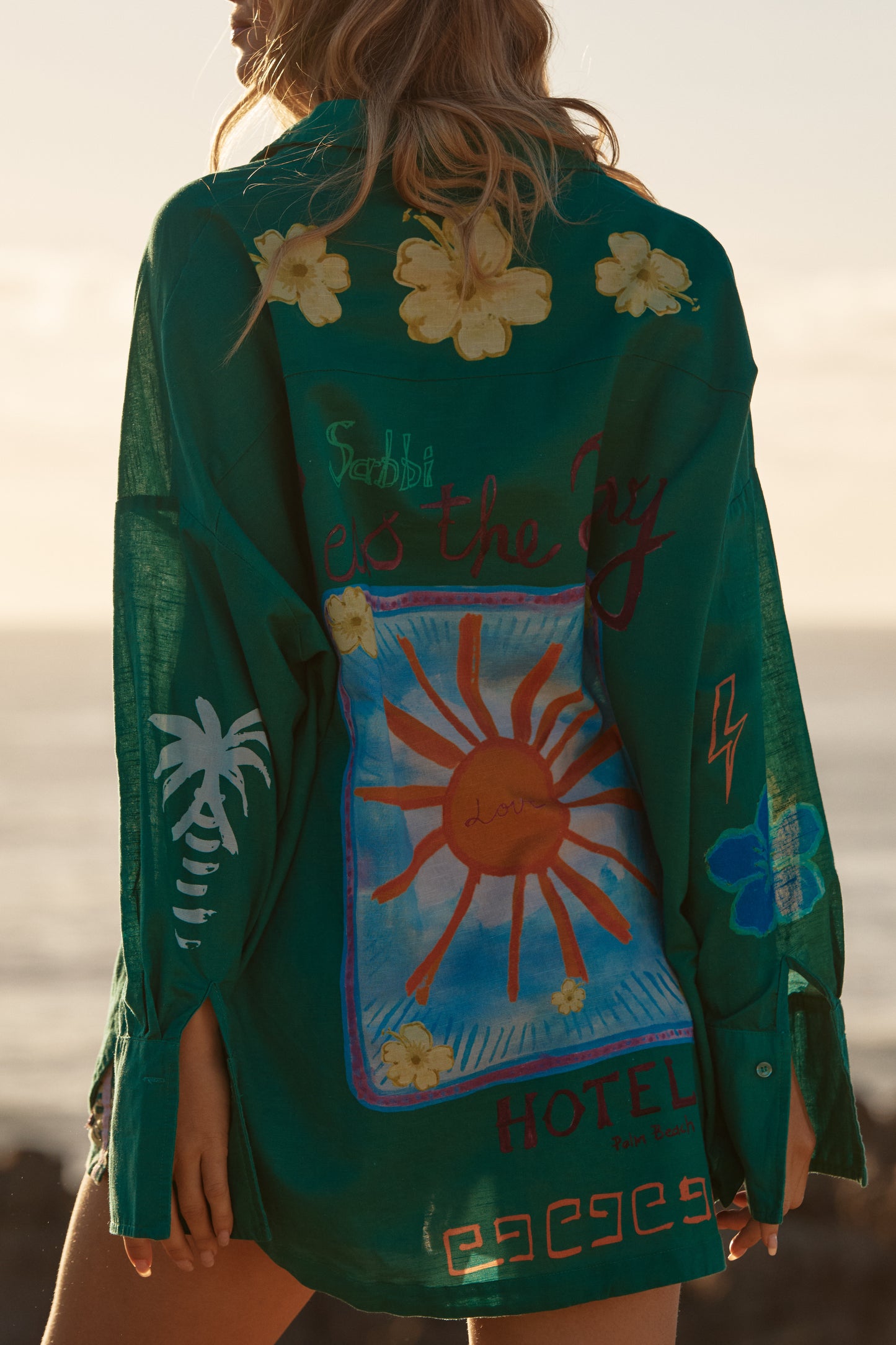 Sabbi - Meet your statement layer for sun-soaked days and golden-hour nights. The Don Julio Shirt – Green is effortlessly cool with a relaxed, oversized fit and a sheer, lightweight feel that moves beautifully with you. Drenched in rich green tones and detailed with playful Seas the Day artwork, this piece brings vintage surf energy with a bold Sabbi twist.