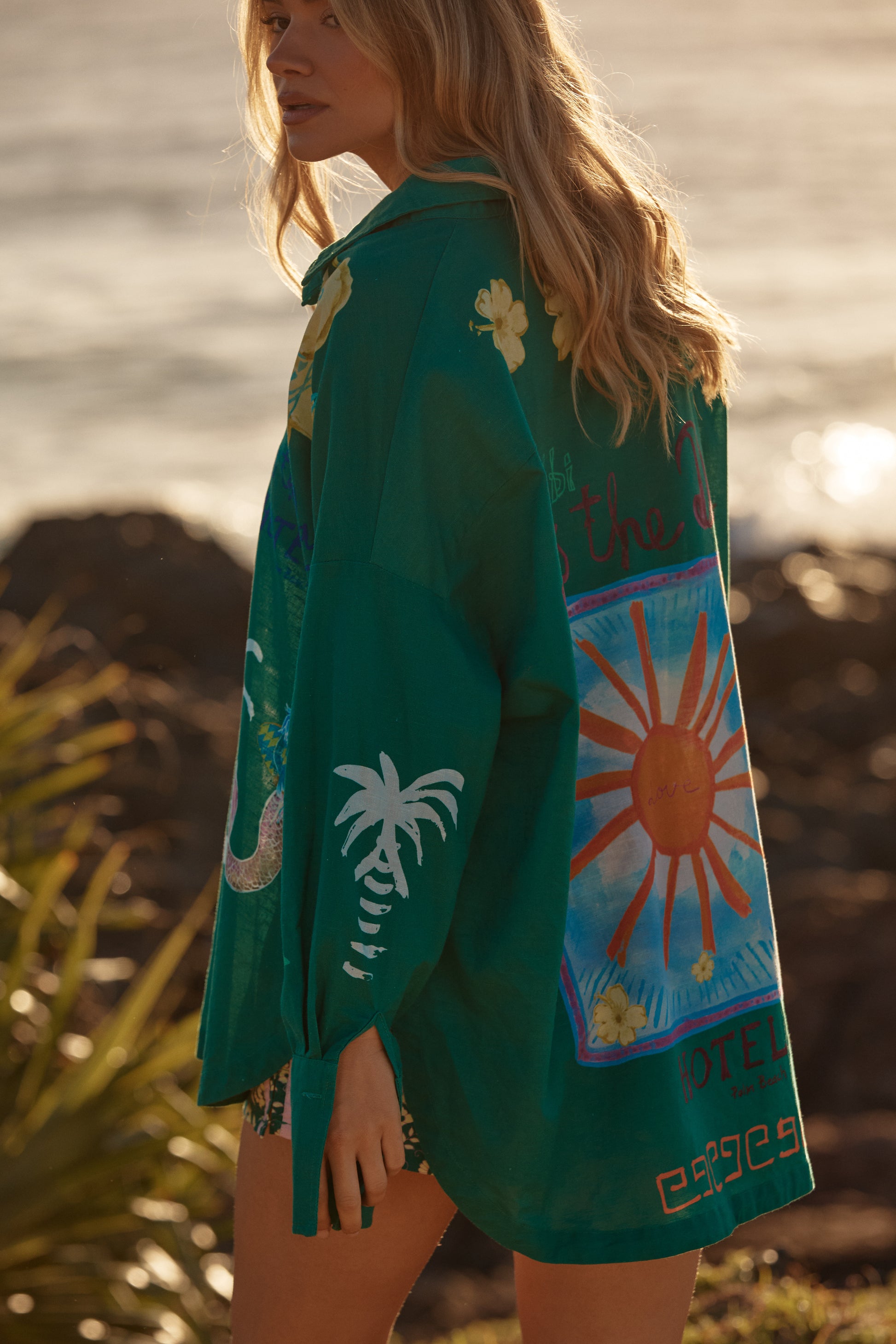 Sabbi - Meet your statement layer for sun-soaked days and golden-hour nights. The Don Julio Shirt – Green is effortlessly cool with a relaxed, oversized fit and a sheer, lightweight feel that moves beautifully with you. Drenched in rich green tones and detailed with playful Seas the Day artwork, this piece brings vintage surf energy with a bold Sabbi twist.