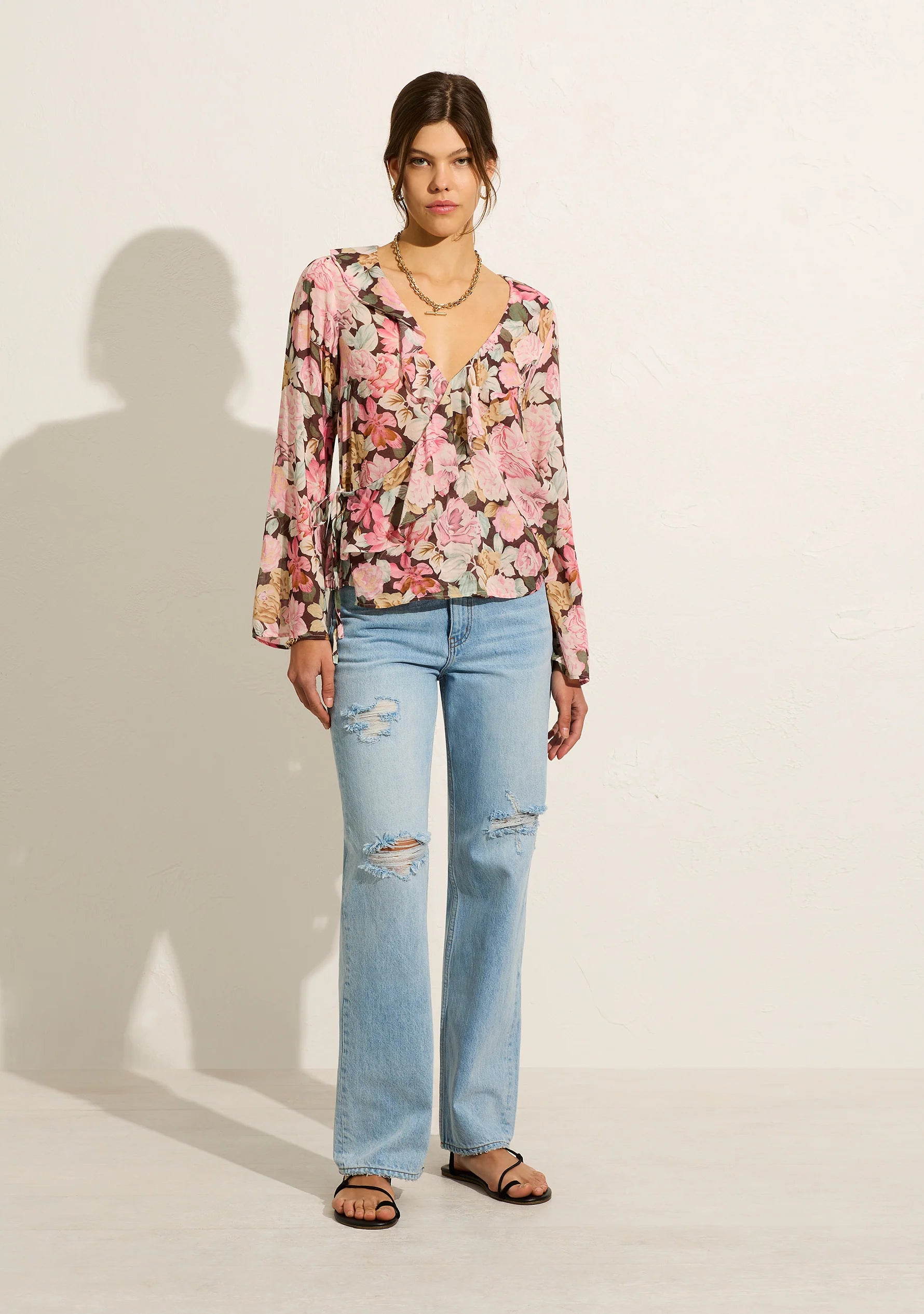 The Sophia Elda Wrap Blouse is crafted from a cotton blend in our feminine blush floral. Featuring a functional wrap design, a V neckline with ruffle details and a choir boy sleeve.