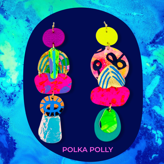 A striking pair of mix matched yet complementary handmade leather earrings. Bold, bright use of colour mixed with iridescent and metallic highlights. Hung from golden stainless steel hooks.

Lightweight and comfortable to wear.

Colour and pattern placements will differ between pairs.