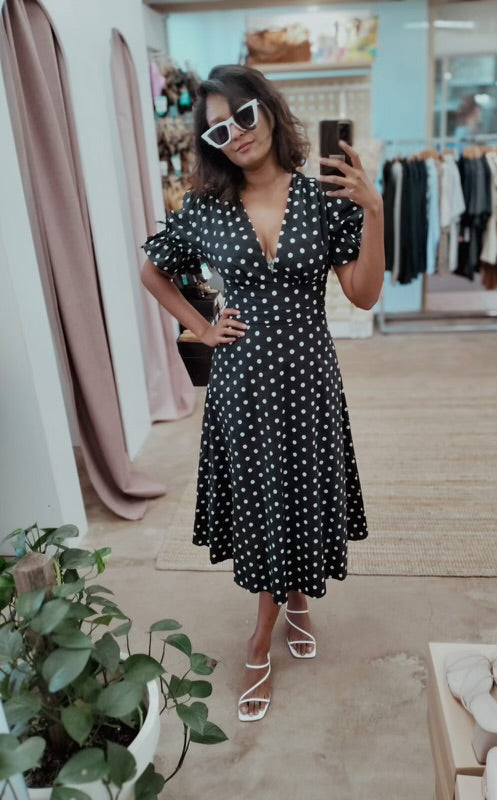 Introducing the elegant black polka dot dress by YH &amp; CO. With its puff sleeve design, this dress exudes a classic and sophisticated look. Crafted with quality materials, it offers both style and comfort for any occasion. Elevate your wardrobe with this timeless piece.
