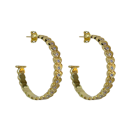 She's fun, she's flirty, she's fabulous... the AMBER Hoops! The iconic and head-turning hoops with a sassy textured heart motif and sparkling CZ.&nbsp;Talk about eye catching&nbsp;and sure to add a playful touch to any look, the Amber hoops will be your go-to accessory. Who doesn’t love a hoop... but make it iconic!