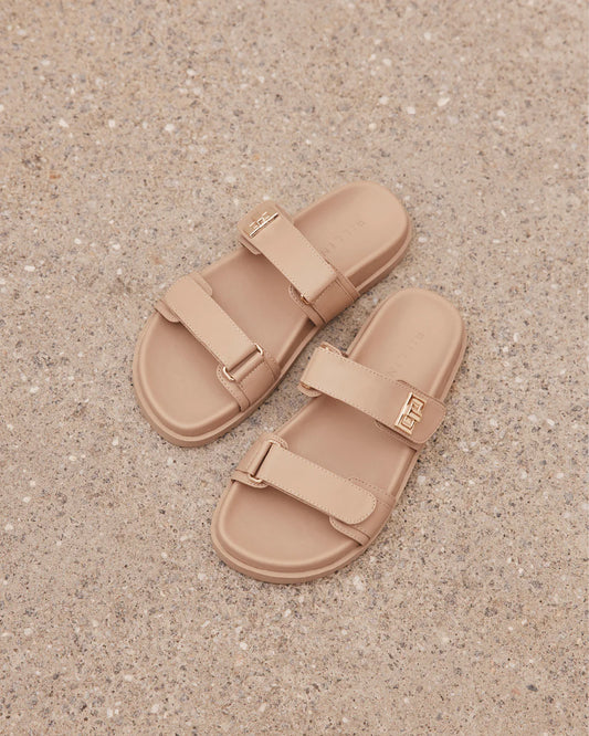 Amylee is a luxe summer slide, available exclusively to Billini.

Get holiday ready with this luxe & easy to wear slide.

Featuring;

flat footbed with chunky exposed sole
open round toe
thick twin strap on upper with adjustable velcro straps
faux buckle on strap in gold hardware detailing
open heel counter
synthetic upper, lining and outsole