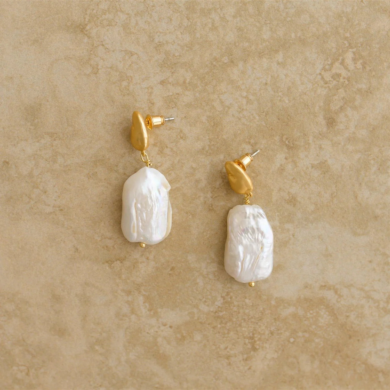 Our ALESSIA earrings are a must have masterpiece, showcasing nature's purest pearls. The perfect pair of earrings for a boho bride!

S925 Gold Plated Sterling Silver
Baroque Pearl/Drop Earrings
Lead,Nickel & Tarnish Free
Hypoallergenic
Varies between 3-4cm