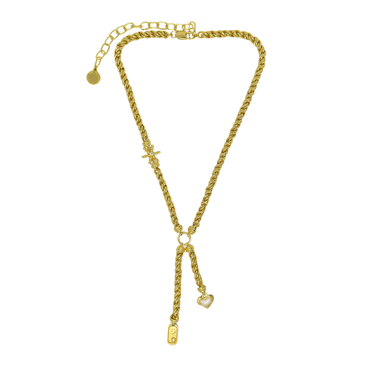 Playful yet powerful, the Cassia Necklace is a bold expression of modern mythology. Designed in a lariat style with a textured, rope-like gold chain, this statement piece features three symbolic charms—star, heart, and dog tag—each suspended at asymmetrical lengths and detailed with pearl enamel accents.
