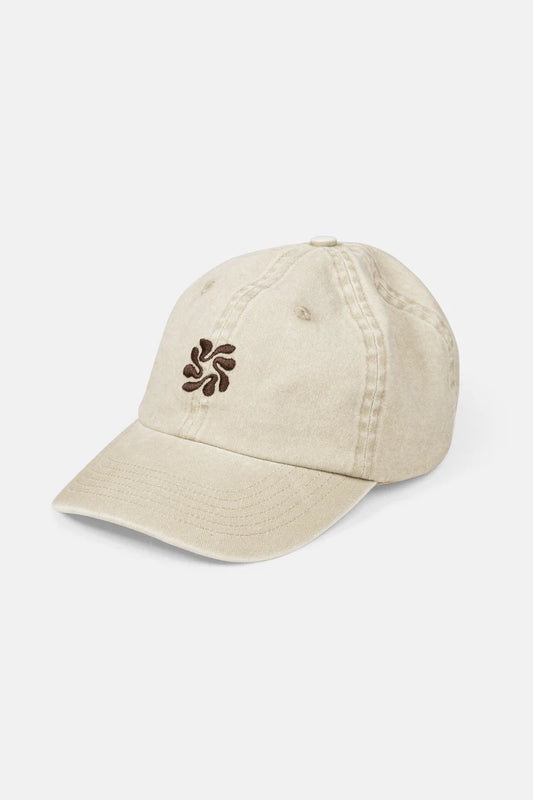 The Traction Cap in Natural features lightweight pigment-dyed twill, a brass adjustable slider, and subtle center front embroidery, making it a timeless accessory.
