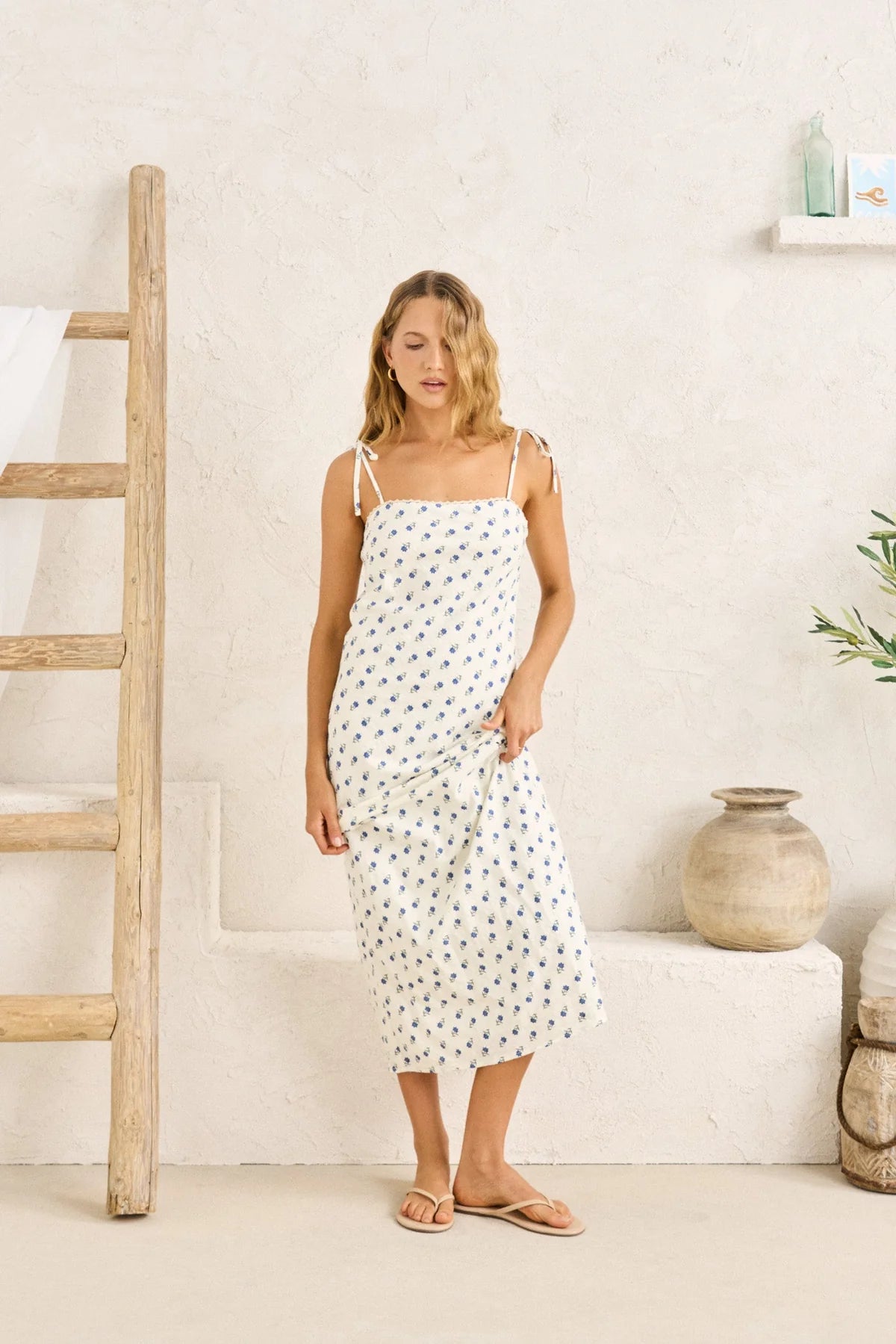 Printed in a vintage-inspired floral, this midi dress is cut on the bias for a soft drape. Finished with scalloped lace trim and tie straps for a subtle romantic edge.