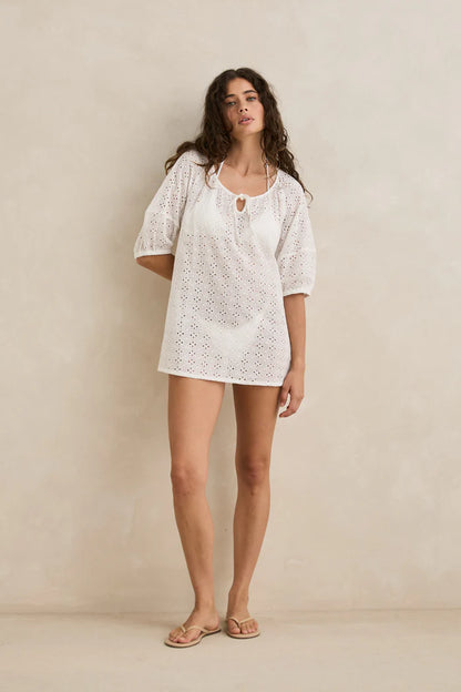 An ethereal overswim essential, the Lucie Mini Dress is crafted from sheer broderie fabric with a relaxed silhouette. Designed with short sleeves, elasticated cuffs, and delicate tie-front detailing. Not lined for an airy feel.



