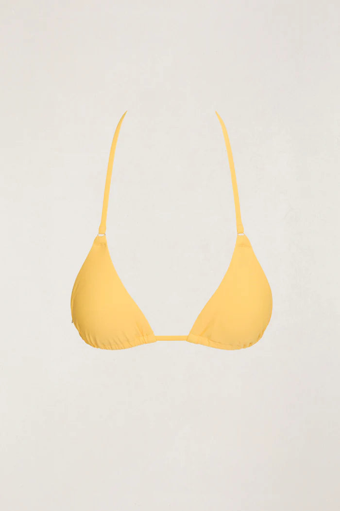 The Classic Slide Tri Top in Butter is recommended for A-C cup sizes and features removable padding for versatile styling. Designed with an adjustable halter neck tie and midriff tie, this top provides a comfortable fit, enhanced by a metal coin logo for a sophisticated touch.