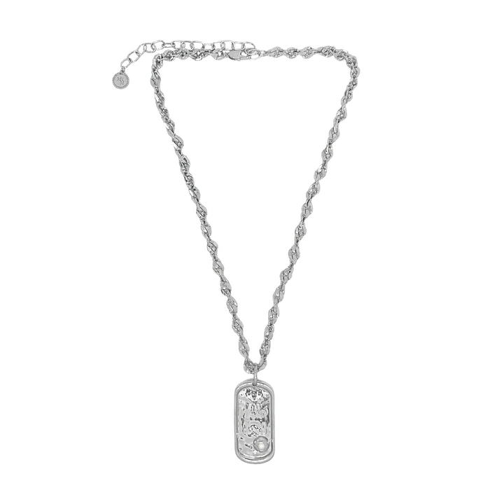Understated and powerful, the Cypress Necklace in silver is a sculptural tribute to identity, elegance, and the enduring pull of the sea. Crafted with a thick, twisted rope-style chain, it features a modern pendant inspired by the shape of a traditional dog tag—reimagined with softened lines and a refined finish. At its center rests a luminous freshwater pearl, adding a touch of organic beauty.