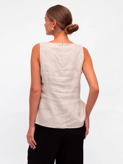 Stay cool and chic in this sleeveless tank. With a crew neckline, zipper in the back, and side splits, it's as functional as it is stylish. And did we mention it's made of luxurious linen fabric? You'll look and feel your best in the Linen Luxe Tank - Oatmeal.