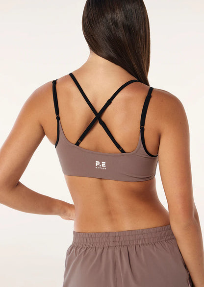 The Distortion Sports Bra in Clay &amp; Chalk Pink comes as part of our FUTURE MODERN Collection. Perfectly designed in our Studio Soft fabrication for low intensity movement, this double layer sports bra offers light compression and adjustable straps at back. Style this piece with the matching Wander Legging to complete the set.