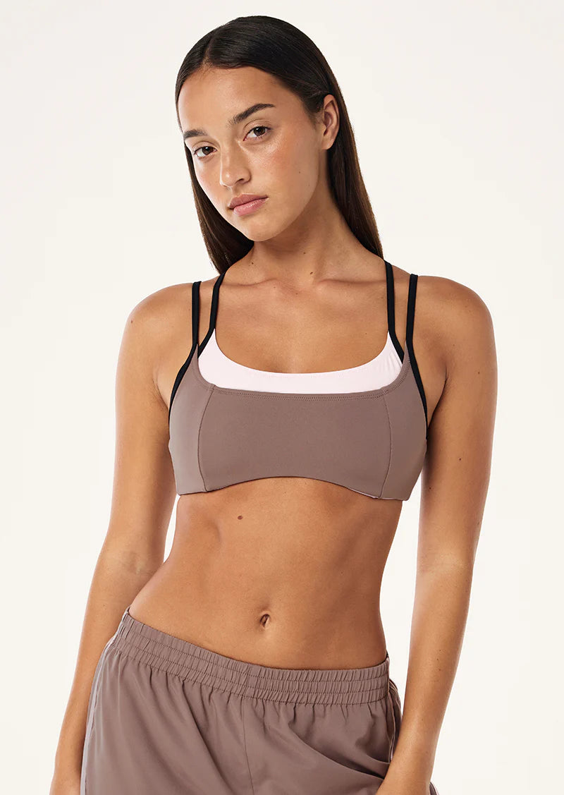 The Distortion Sports Bra in Clay &amp; Chalk Pink comes as part of our FUTURE MODERN Collection. Perfectly designed in our Studio Soft fabrication for low intensity movement, this double layer sports bra offers light compression and adjustable straps at back. Style this piece with the matching Wander Legging to complete the set.