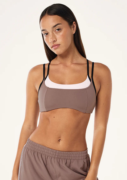 The Distortion Sports Bra in Clay &amp; Chalk Pink comes as part of our FUTURE MODERN Collection. Perfectly designed in our Studio Soft fabrication for low intensity movement, this double layer sports bra offers light compression and adjustable straps at back. Style this piece with the matching Wander Legging to complete the set.