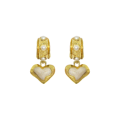 The&nbsp;Elena Earrings are a romantic nod to sun-soaked summers and ancient beauty,&nbsp;where antique ruins meet modern elegance. Featuring heart-shaped silhouettes bathed in gold, adorned with lustrous freshwater pearls and hand applied pearlescent enamel detailing.



Part of our Sirens Collection, these earrings draw from the timeless charm of the Mediterranean—where molten textures echo the ruins of antiquity, and every shimmer captures the glint of sea and sky. 