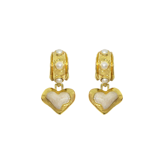 The&nbsp;Elena Earrings are a romantic nod to sun-soaked summers and ancient beauty,&nbsp;where antique ruins meet modern elegance. Featuring heart-shaped silhouettes bathed in gold, adorned with lustrous freshwater pearls and hand applied pearlescent enamel detailing.



Part of our Sirens Collection, these earrings draw from the timeless charm of the Mediterranean—where molten textures echo the ruins of antiquity, and every shimmer captures the glint of sea and sky. 