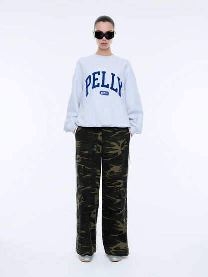 The Anniversary Sweatshirt is crafted from premium cotton terry, offering a soft yet durable texture. Featuring an oversized fit with a crew neckline, ribbed cuffs, and a ribbed neckband, it pairs comfort with elevated style. The exclusive Ena Pelly design is highlighted by a terry applique collegiate print, giving this sweatshirt its distinctive edge.