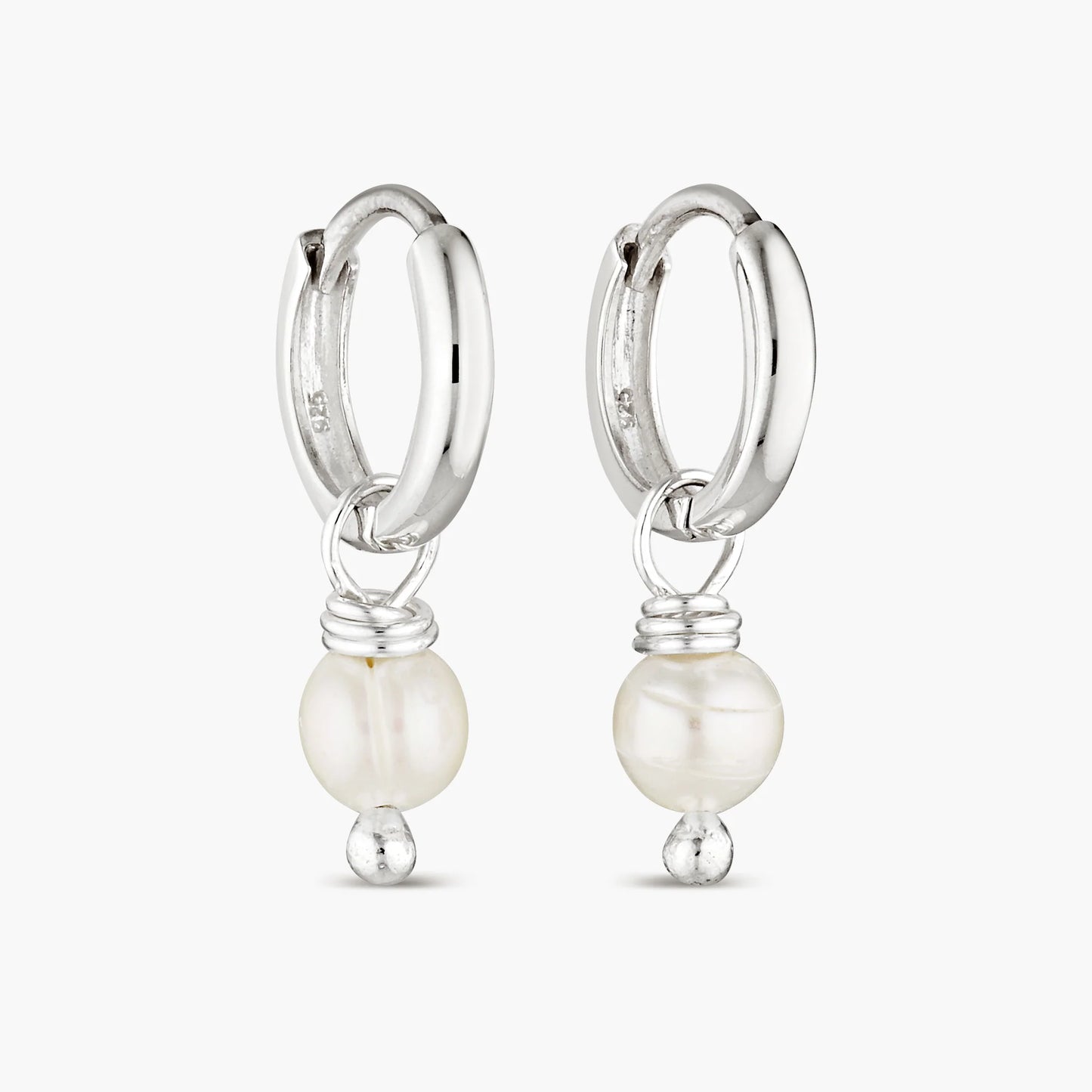 Elevate your style with our Pearl Layla Huggies, a timeless addition to your collection. These earrings feature sterling silver huggies adorned with lustrous freshwater pearls, symbolizing purity, wisdom, and maternal influence. Pearls are known for their calming and balancing properties, making these earrings not just a fashion statement, but also a source of inner peace and harmony.