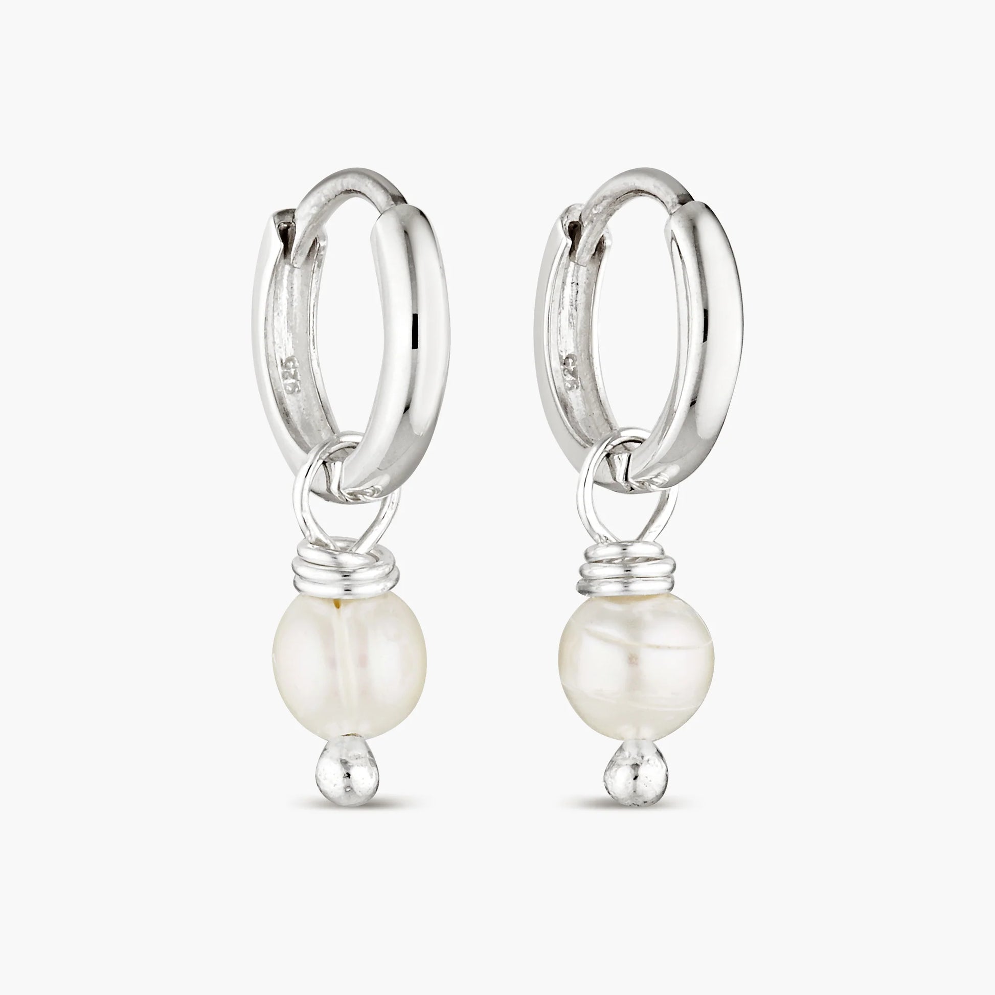 Elevate your style with our Pearl Layla Huggies, a timeless addition to your collection. These earrings feature sterling silver huggies adorned with lustrous freshwater pearls, symbolizing purity, wisdom, and maternal influence. Pearls are known for their calming and balancing properties, making these earrings not just a fashion statement, but also a source of inner peace and harmony.