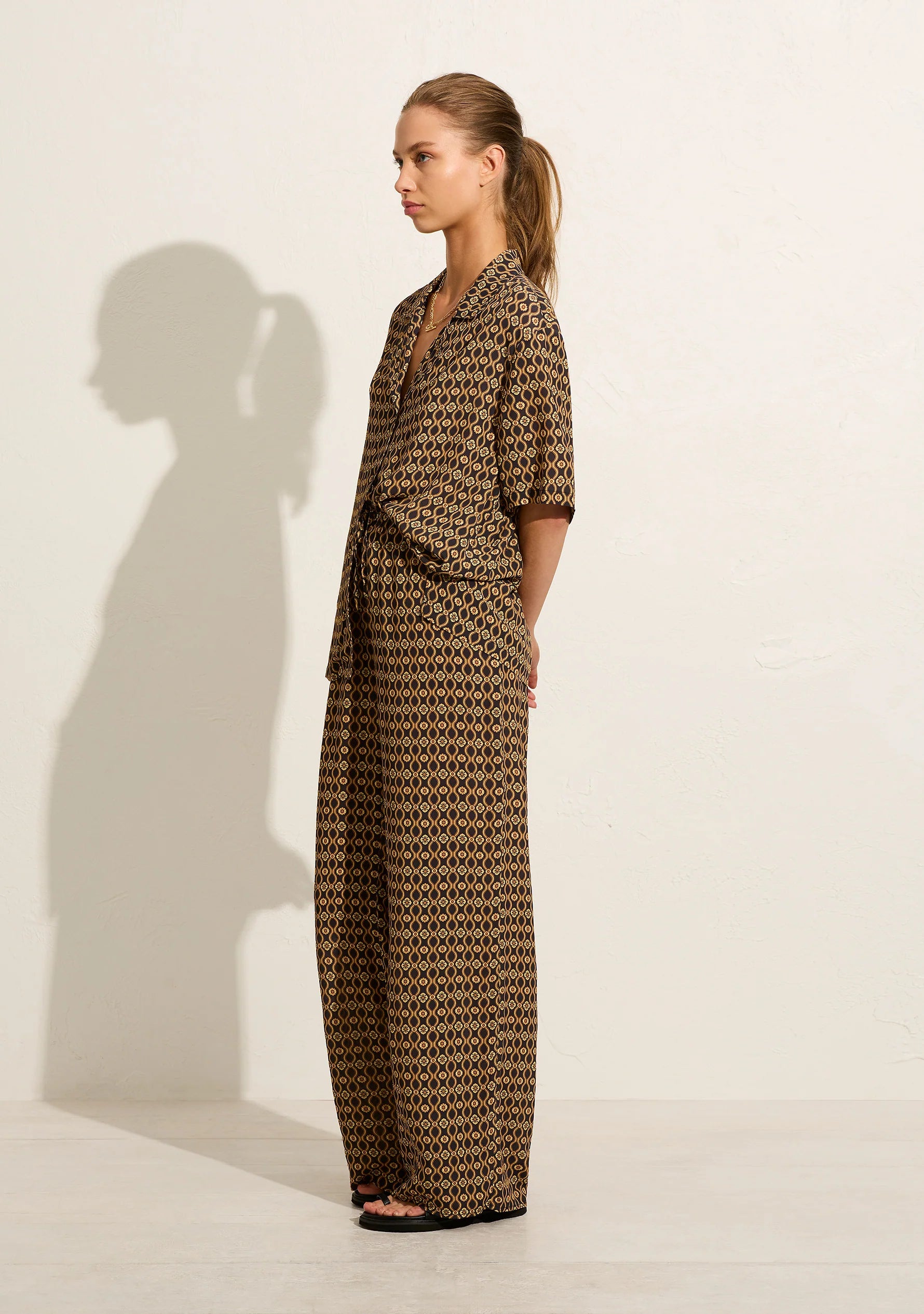 The high-waisted Saffron Martha Pant is crafted from viscose crepe in this season's geo print, offering a straight-leg design with an elasticated waistband and functional drawcord