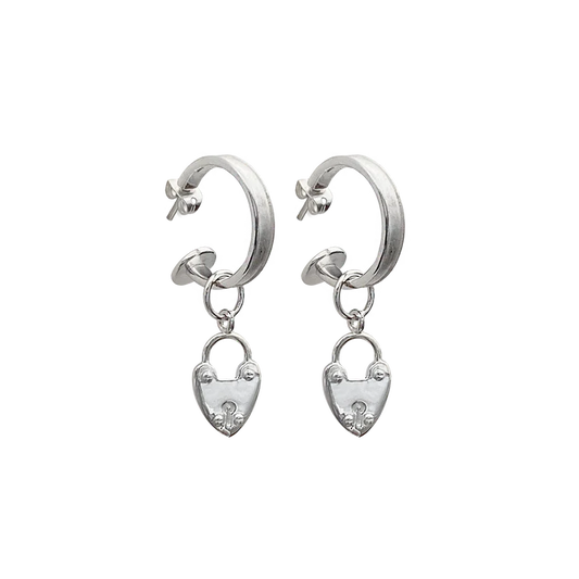 Our beloved Heart Mini Hoops, now in silver, are a perfect addition to any outfit. Whether worn with our&nbsp;gorgeous heart locket charms or solo, yes the charms are removable! These mini&nbsp;silver hoops are&nbsp;such a cute &amp; eye-catching accessory.&nbsp;Maybe you're running errands, attending a special event, or exercising, these&nbsp;small but mighty earrings are a perfect complement to your look. They're your go-to everyday earring that are never boring.&nbsp;