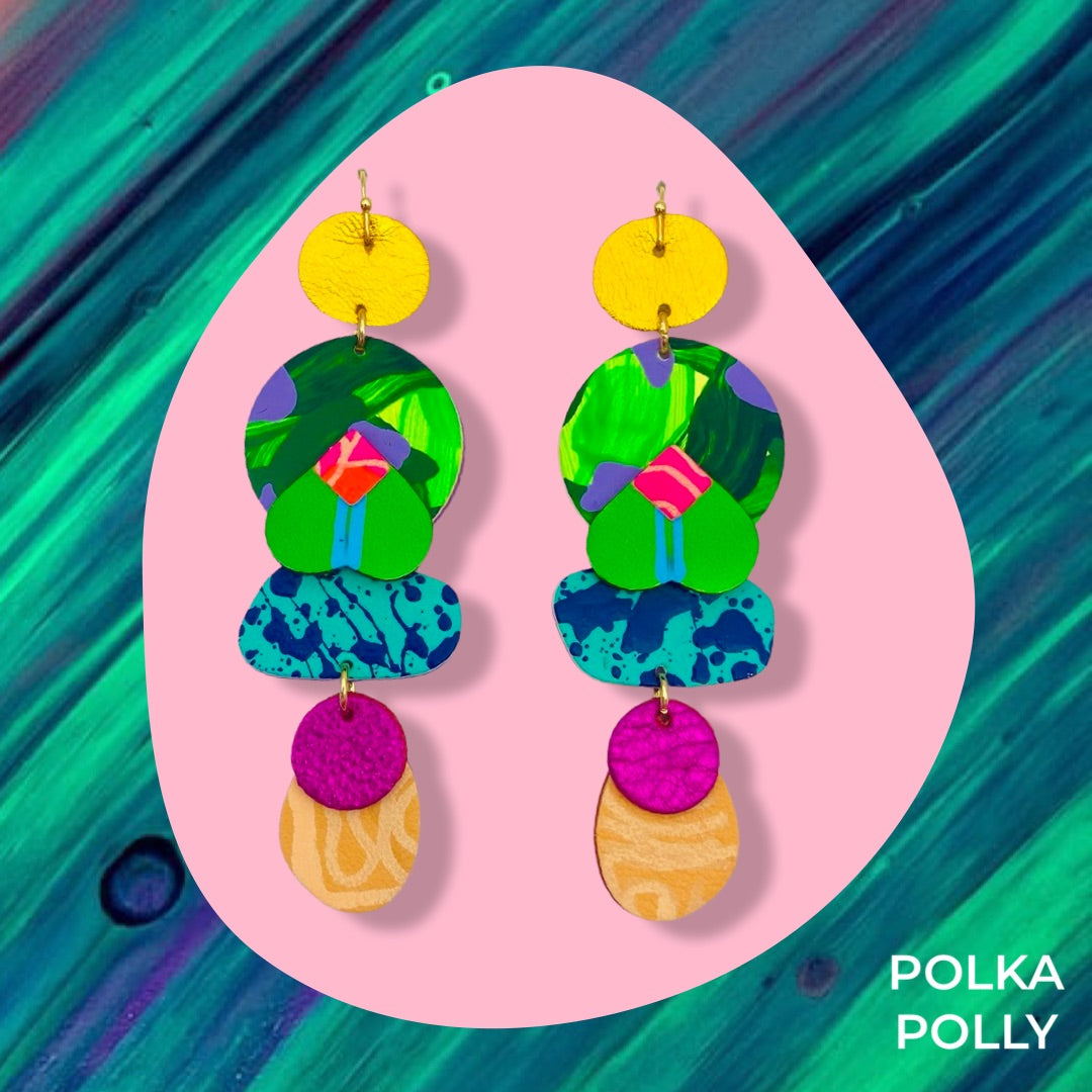 A striking pair of vibrant rainbow coloured handmade leather earrings. Bold, bright use of colour mixed with hand painted and metallic highlights. Hung from golden stainless steel hooks.