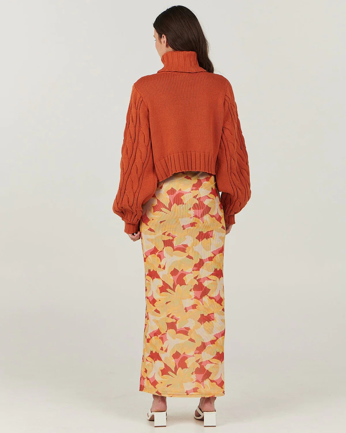 In a warm amber hue, this gorgeous cable knit sweater by Charlie Holiday features a crop body with slouchy blouson sleeves. A beautiful knit you can dress up or down, team it with a floral maxi skirt or with high-waisted jeans and ankle boots.