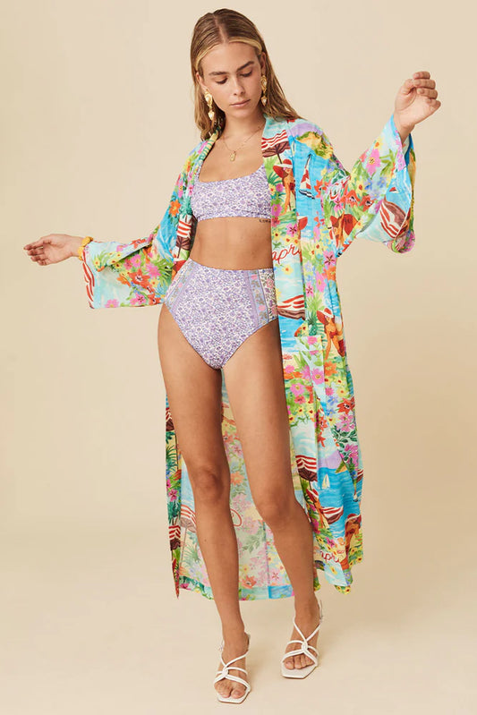 The Capri Maxi Robe in Ocean breathes sun-drenched days spent sipping cocktails and summer romance. Crafted for wanderlust hearts our Robe features hand drawn tropical floral motifs and scattered beach umbrellas by the bluest water